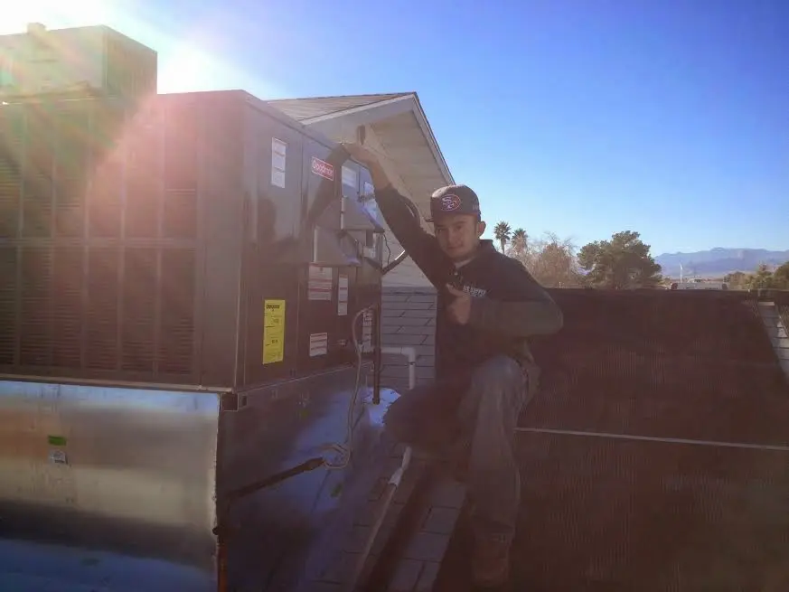 HVAC technician performing HVAC Inspection on a rooftop unit in West Brandywine